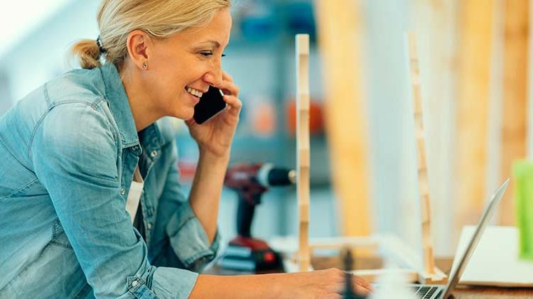 Small business owner reviewing goals on her computer.