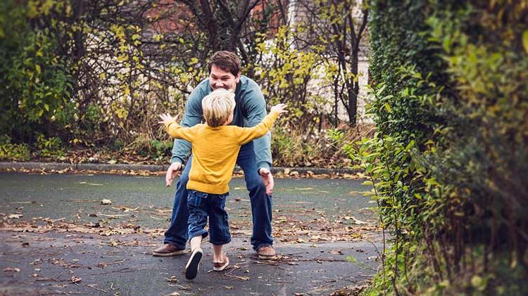 Child running into father’s arms.