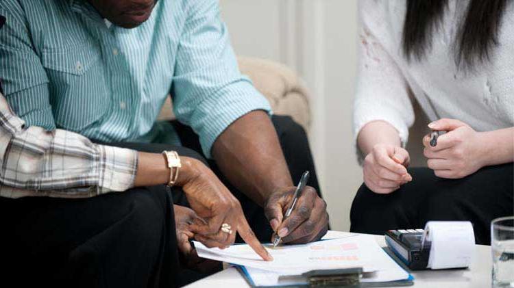 Couple signing a rental lease.